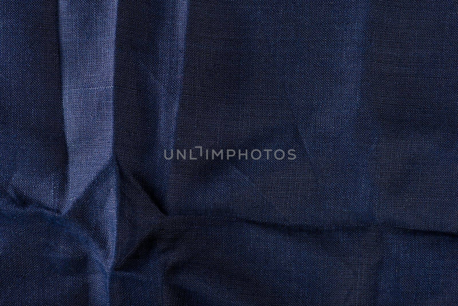 Texture of fabric for furniture upholstery. Wear and water resistant fabric in deep folds top view. Blue fabric texture closeup top view