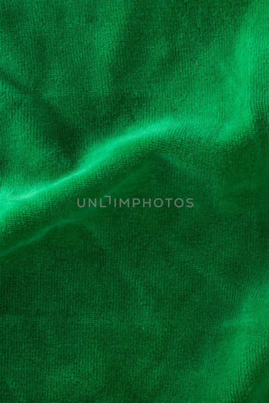 The texture of a microfiber cloth close-up. Napkins for cleaning and cleaning green surfaces. Washable