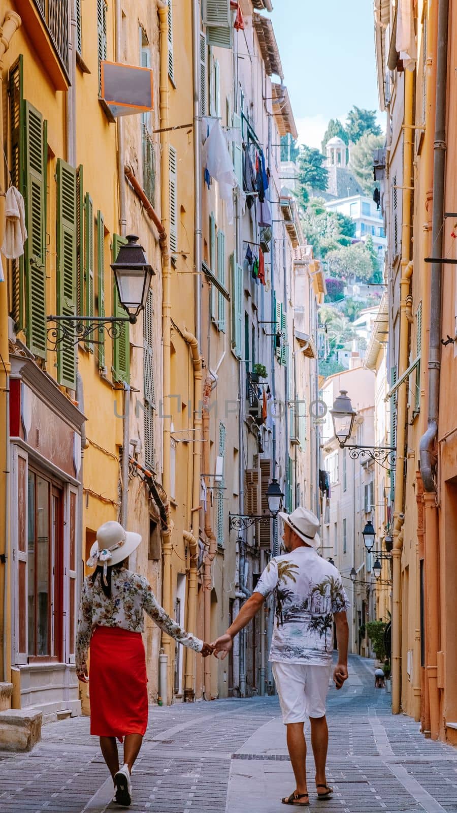 A couple of men and women on summer vacation in France visit the city of Menton Cote d Azure on the French Riviera