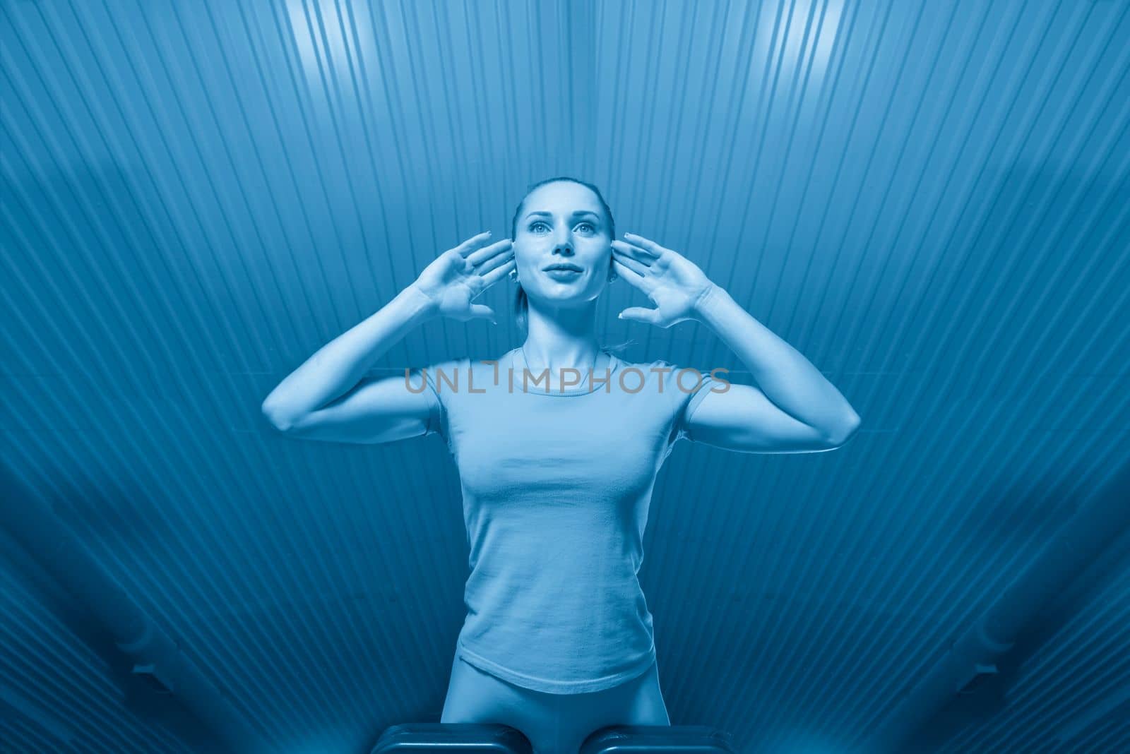 Young sporty woman workout on exercises machine in gym.