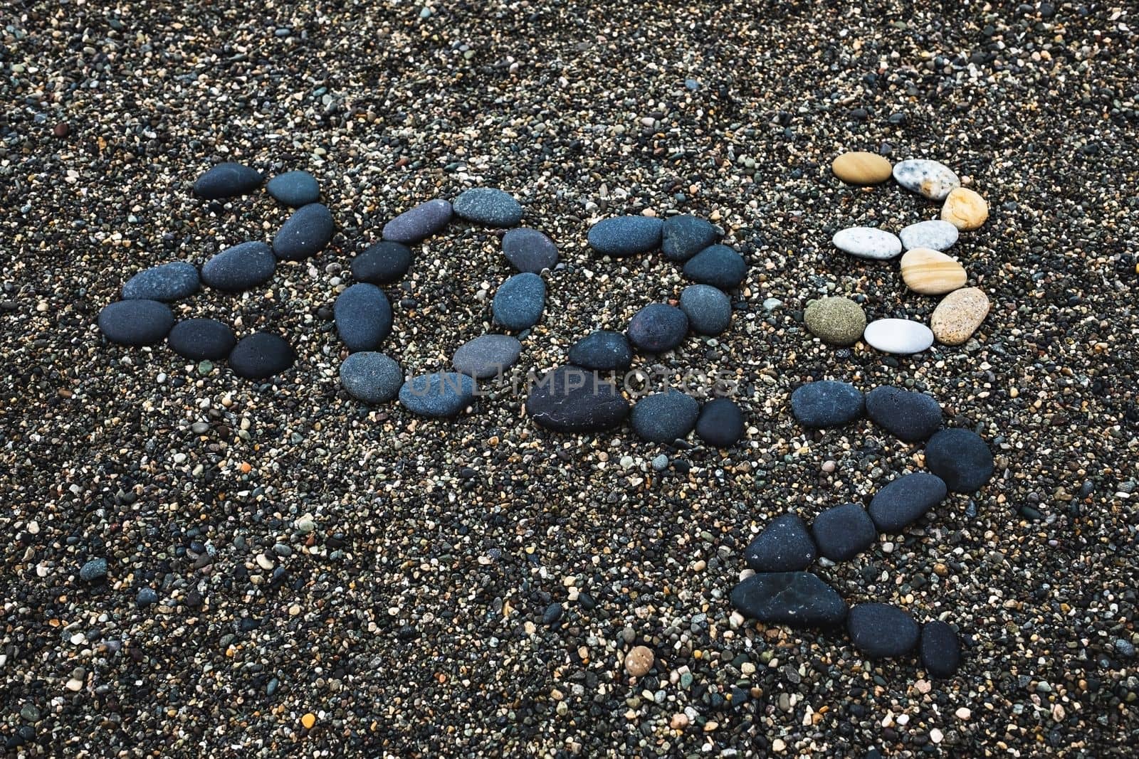 Number 2023 as a New Year concept made from stones on pebble beach  by koldunov