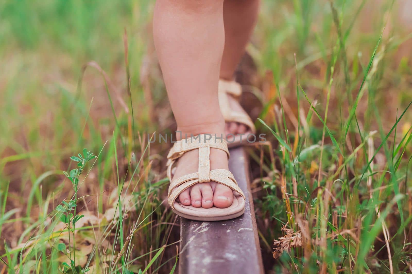 Tiny feet of a child walking the railroad.