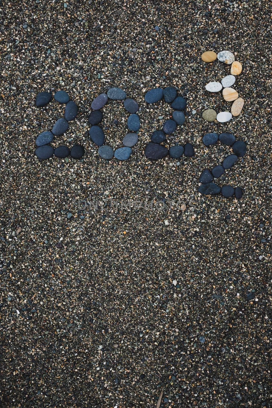 Number 2023 as a New Year concept made from stones on pebble beach  by koldunov