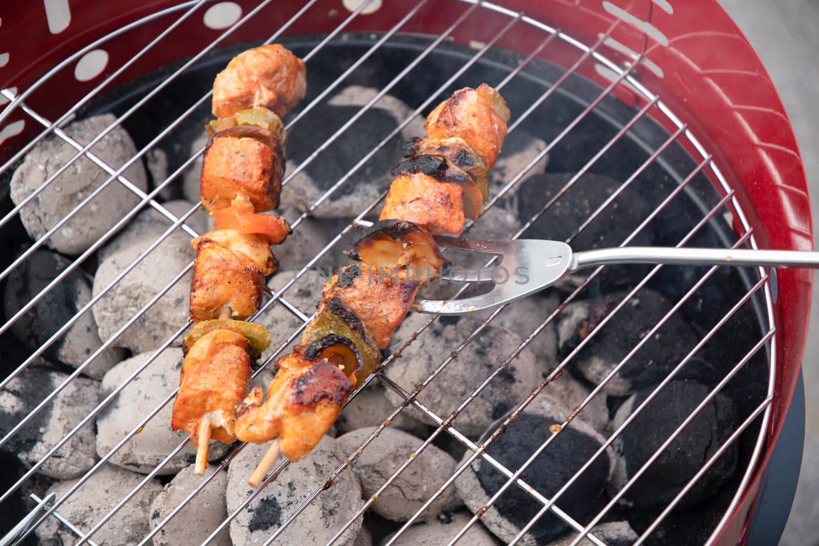 summer picnic with barbecue marinated chicken skewers with grilled vegetables on the terrace, colorful food. High quality photo