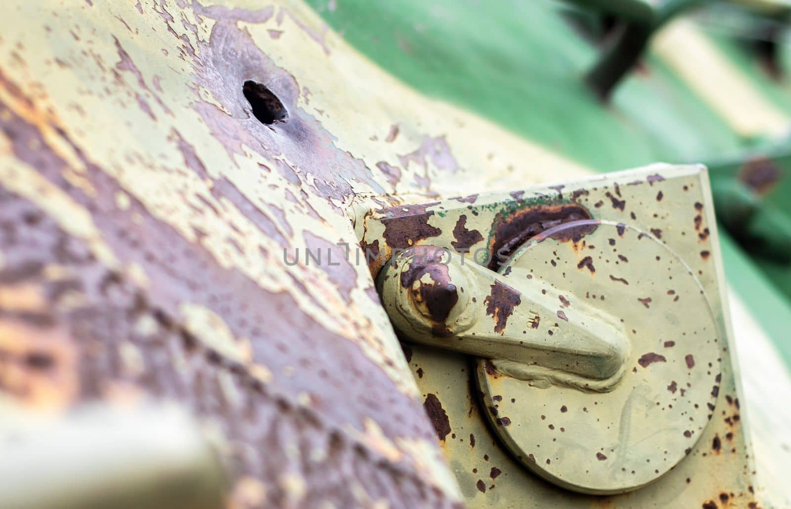 Hole or hole, armor deformation from a projectile close-up. Damaged armor of a Russian armored personnel carrier by shell fragments. War in Ukraine. Russian combat vehicle with holes in the armor
