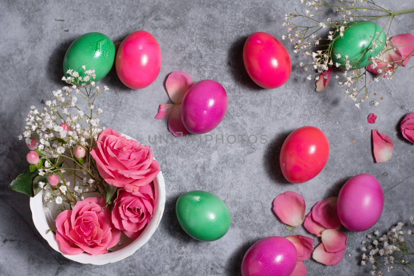 colorful easter eggs scattered on gray concrete background, top view, High quality photo