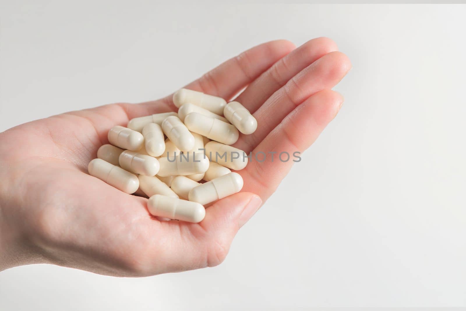 Probiotics. Preparation for restoration of intestinal microflora. Handful of white capsules with probiotic powder inside. The concept of health care and recovery of health after taking antibiotics.