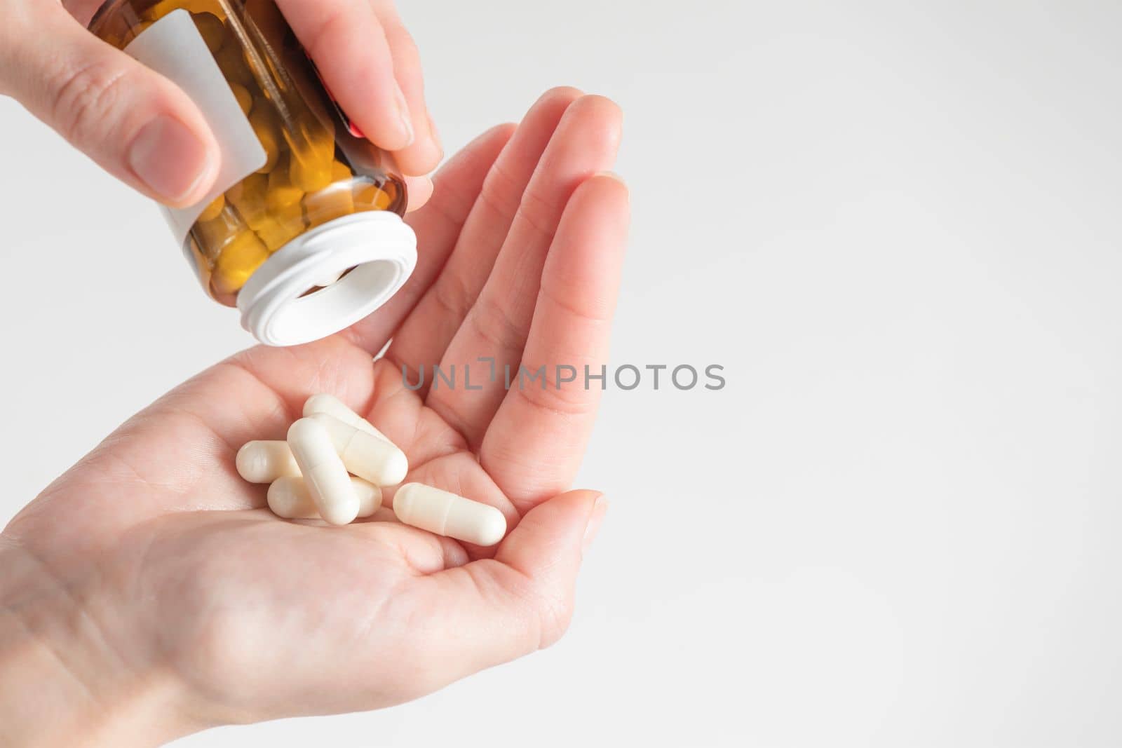 Probiotics. Preparation for restoration of intestinal microflora. Handful of white capsules with probiotic powder inside. The concept of health care and recovery of health after taking antibiotics.