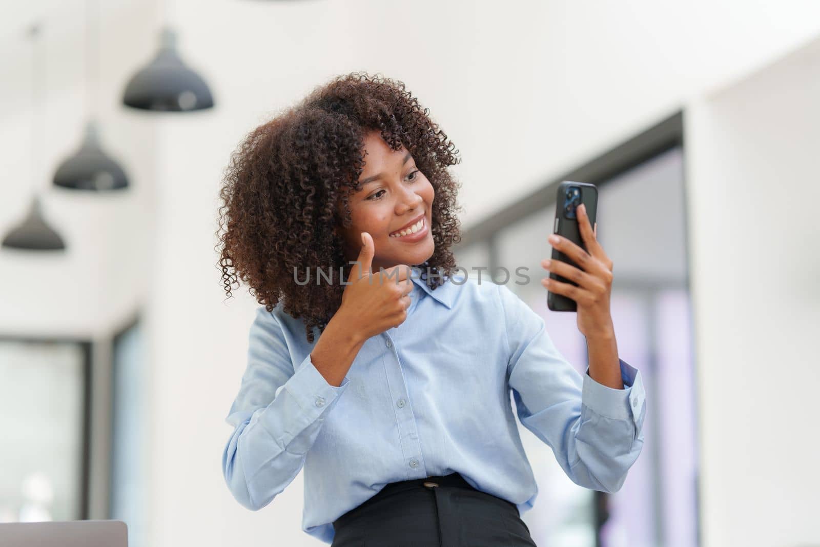 Business black woman having phone conversation with client in office. Woman reading news, report or email. Online problem, finance mistake, troubleshooting by itchaznong