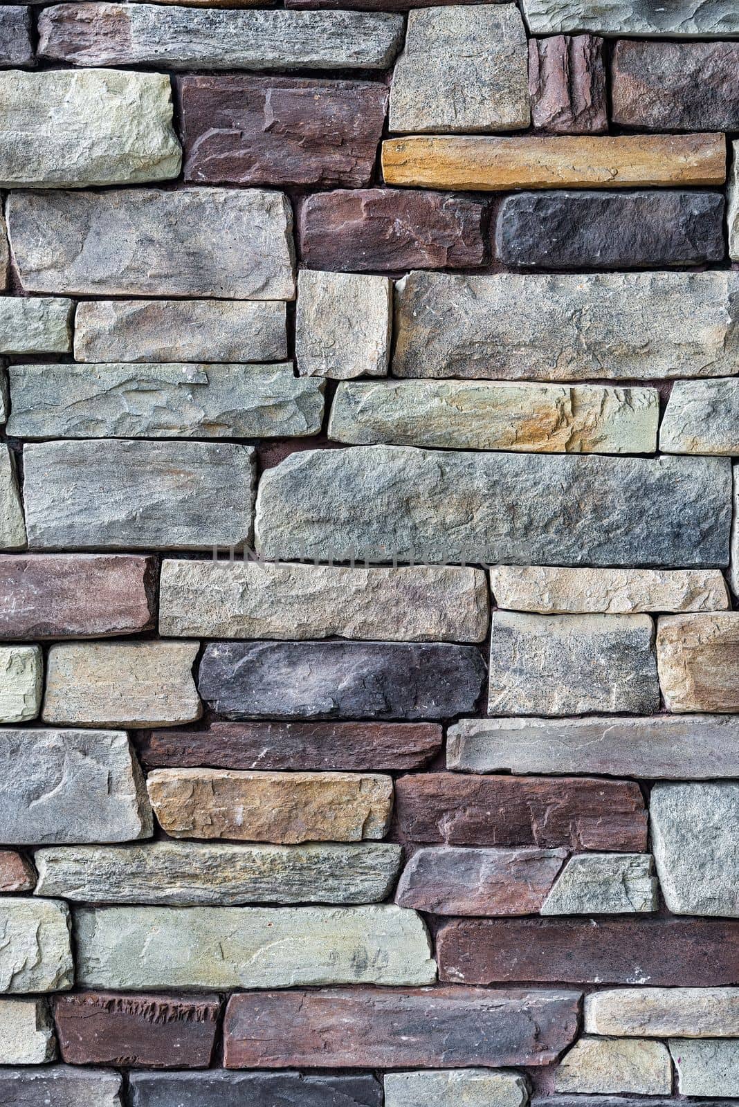 Decorative brown and grey colored stone setting. Cut stone wall texture
