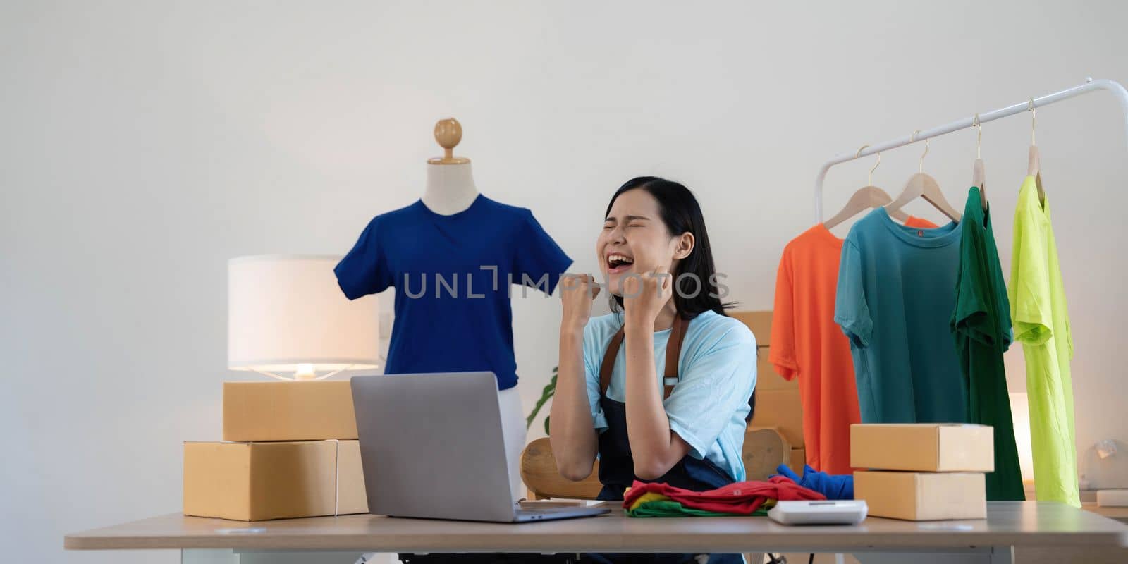 Young asian women happy after new order from customer. Surprise and shock face of asian woman success on making big sale of his online store. Online Selling. Online Shopping by wichayada