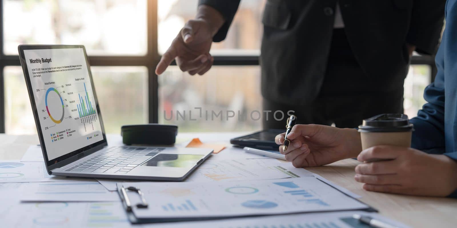Business People Meeting using laptop computer,calculator,notebook,stock market chart paper for analysis Plans to improve quality next month. Conference Discussion Corporate Concept. by wichayada