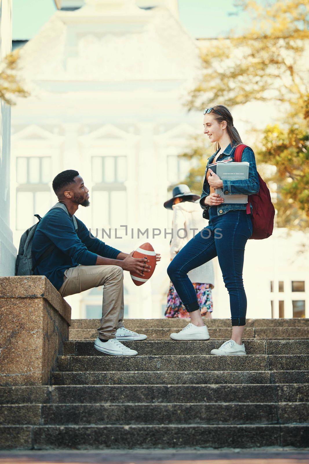 College, education and communication of friends at stairs for study lesson discussion at campus. Gen z, interracial and university students in talk on outdoor steps of educational building. by YuriArcurs