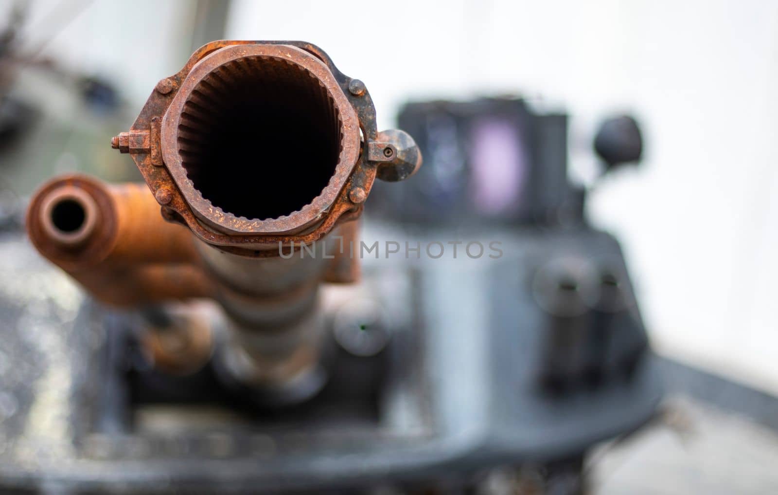 Tank gun, barrel muzzle of a military army close-up. Broken burnt tank. Barrel of a tank gun, selective focus. Destroyed and burned tank, military equipment in the vicinity of Kyiv. War in Ukraine. by Roshchyn