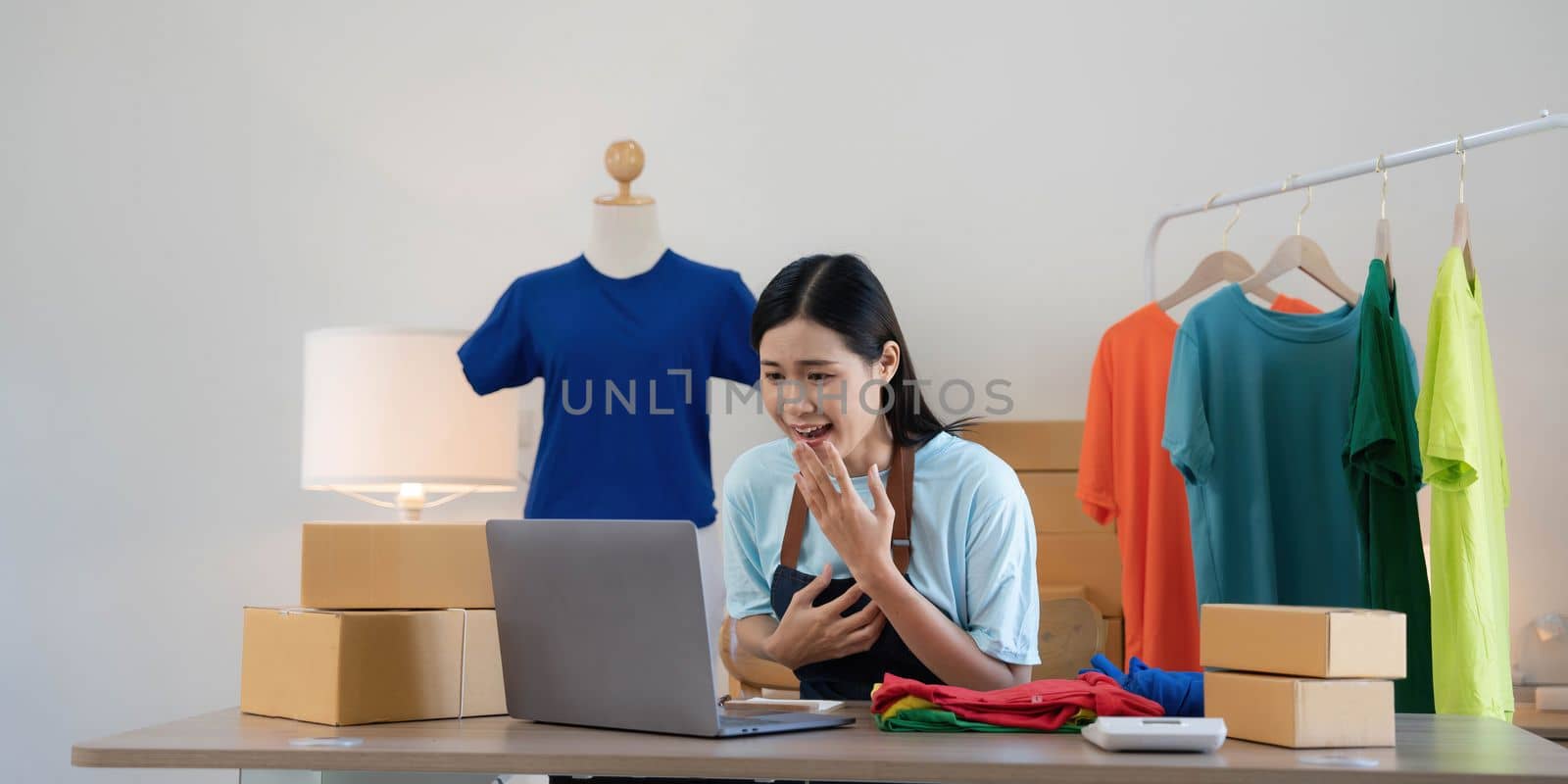 Young asian women happy after new order from customer. Surprise and shock face of asian woman success on making big sale of his online store. Online Selling.