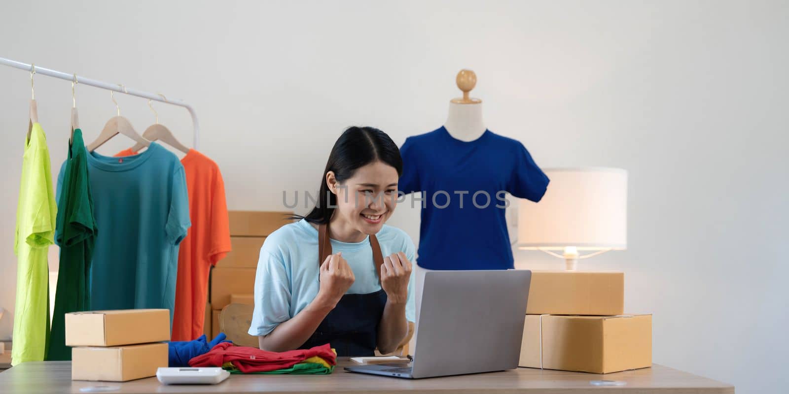 Young asian women happy after new order from customer. Surprise and shock face of asian woman success on making big sale of his online store. Online Selling.