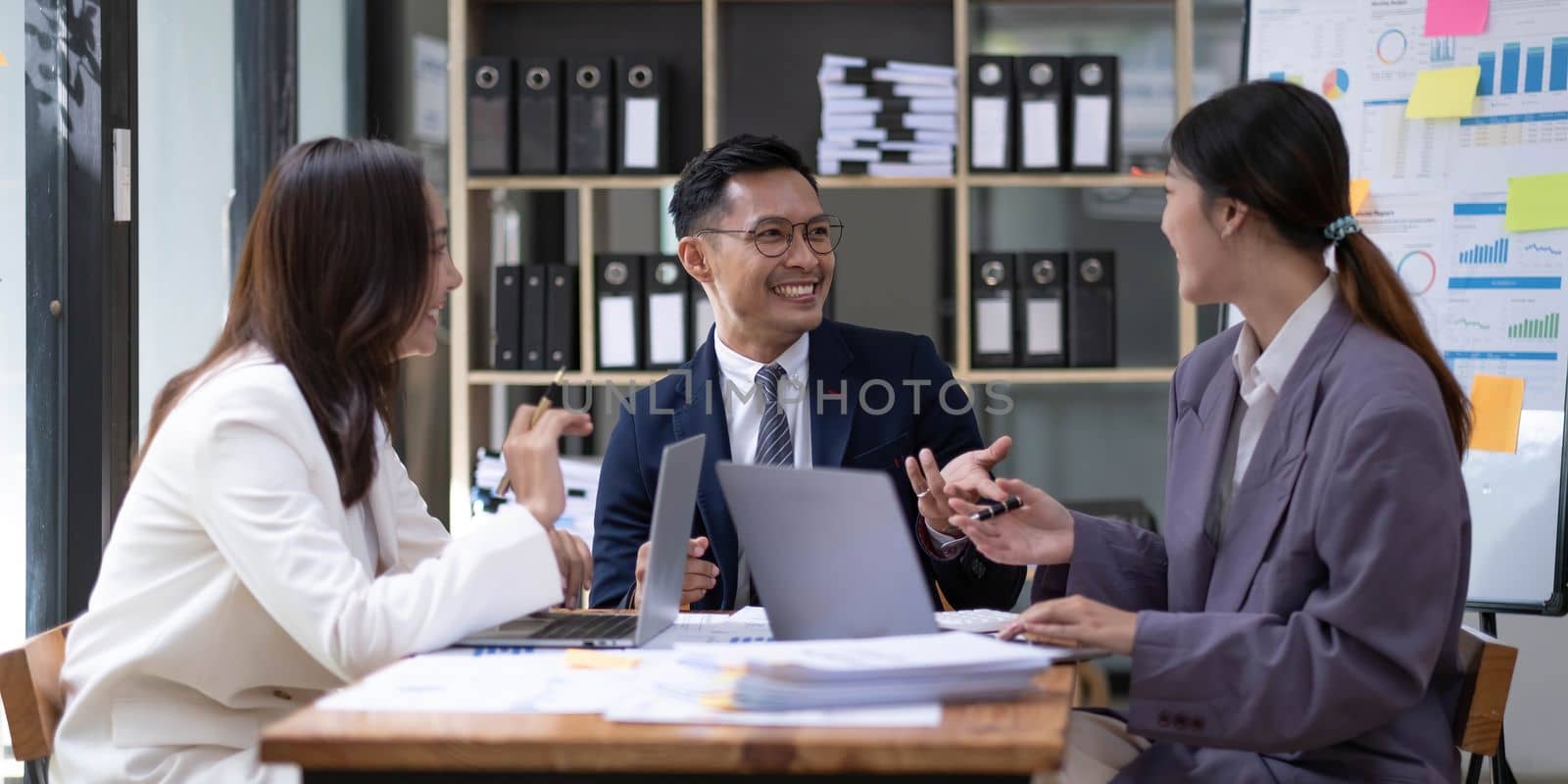 Group of young asian modern people in smart casual wear having a brainstorm meeting. Group of young asian business people discussing in the meeting...