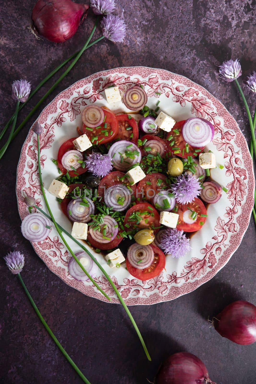 cherry tomato salad with purple onion, feta chees and balsamic vinegar, flat lay by KaterinaDalemans