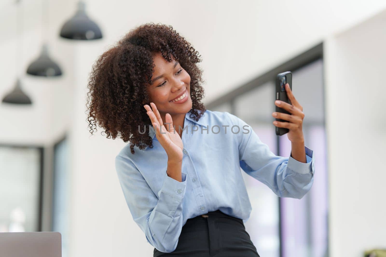 Business black woman having phone conversation with client in office. Woman reading news, report or email. Online problem, finance mistake, troubleshooting.