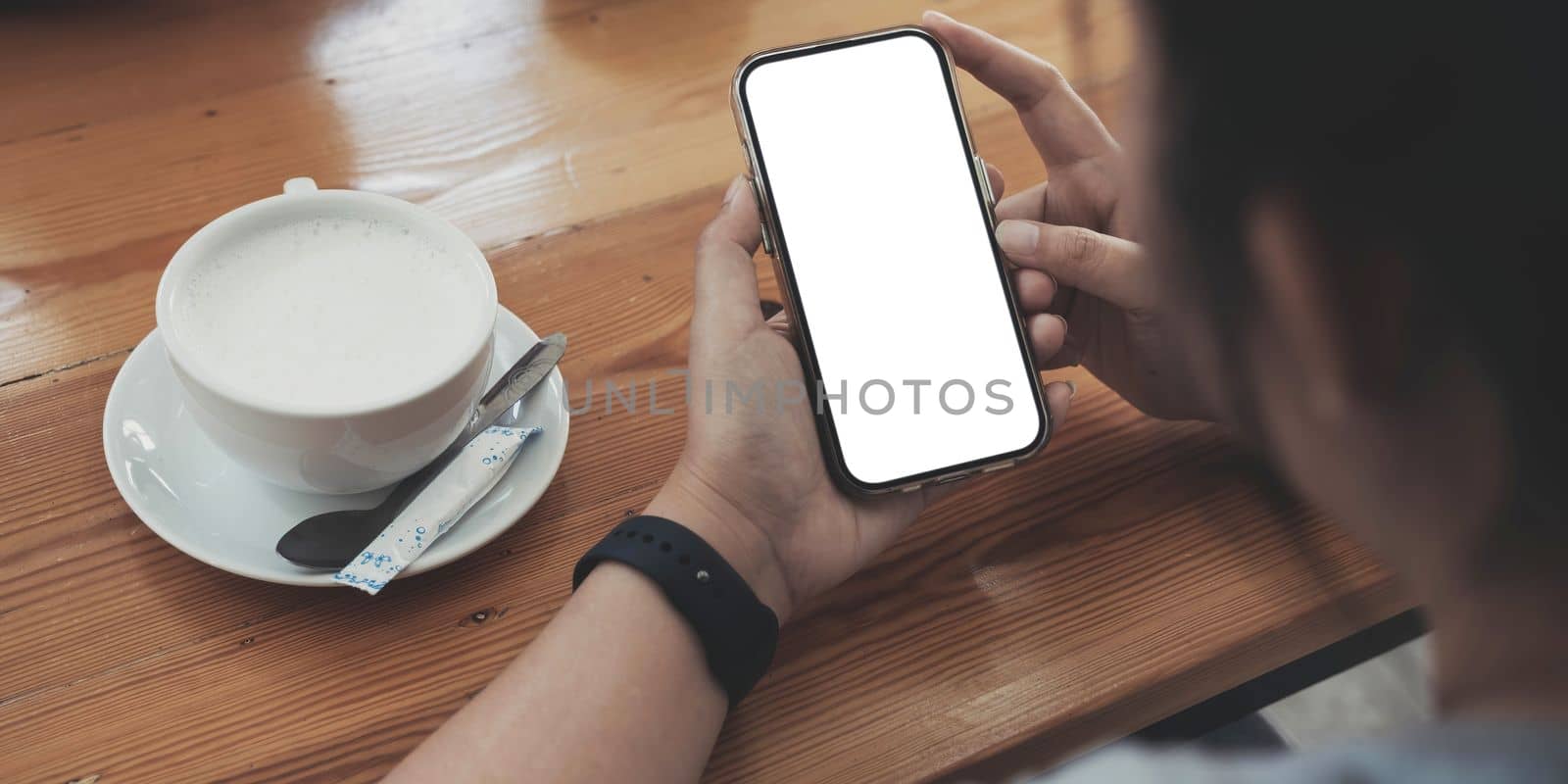 Close up of woman using cell phone,sending massages on the coffee shop.having sunbath.Phone with black screen,texting,video calls, by wichayada