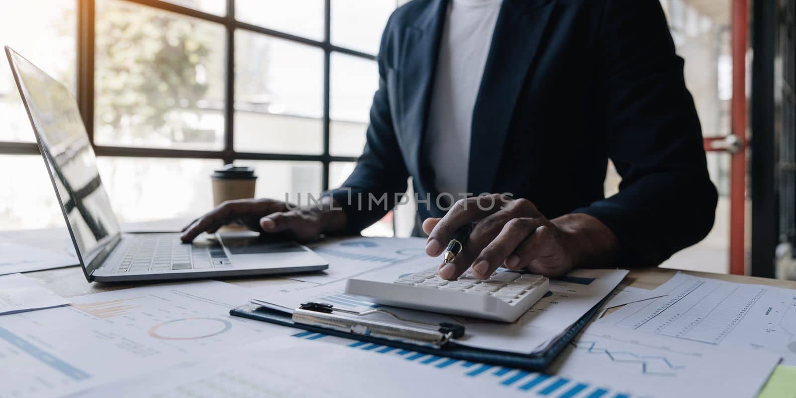 Close up man working about financial with calculator at his office to calculate expenses, Accounting concept..