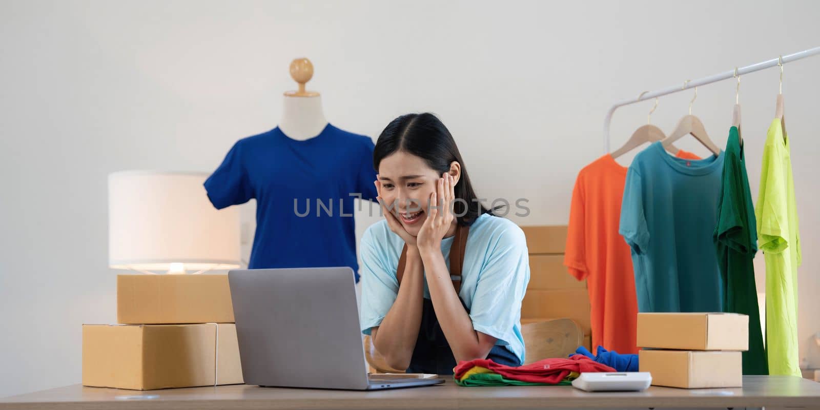 Young asian women happy after new order from customer. Surprise and shock face of asian woman success on making big sale of his online store. Online Selling.