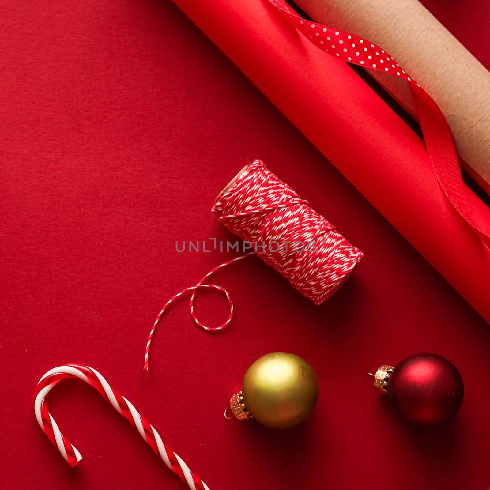Christmas preparation, boxing day and holidays gift giving, xmas craft paper and ribbons for gifts boxes on red background as wrapping tools and decorations, diy presents as holiday flat lay design