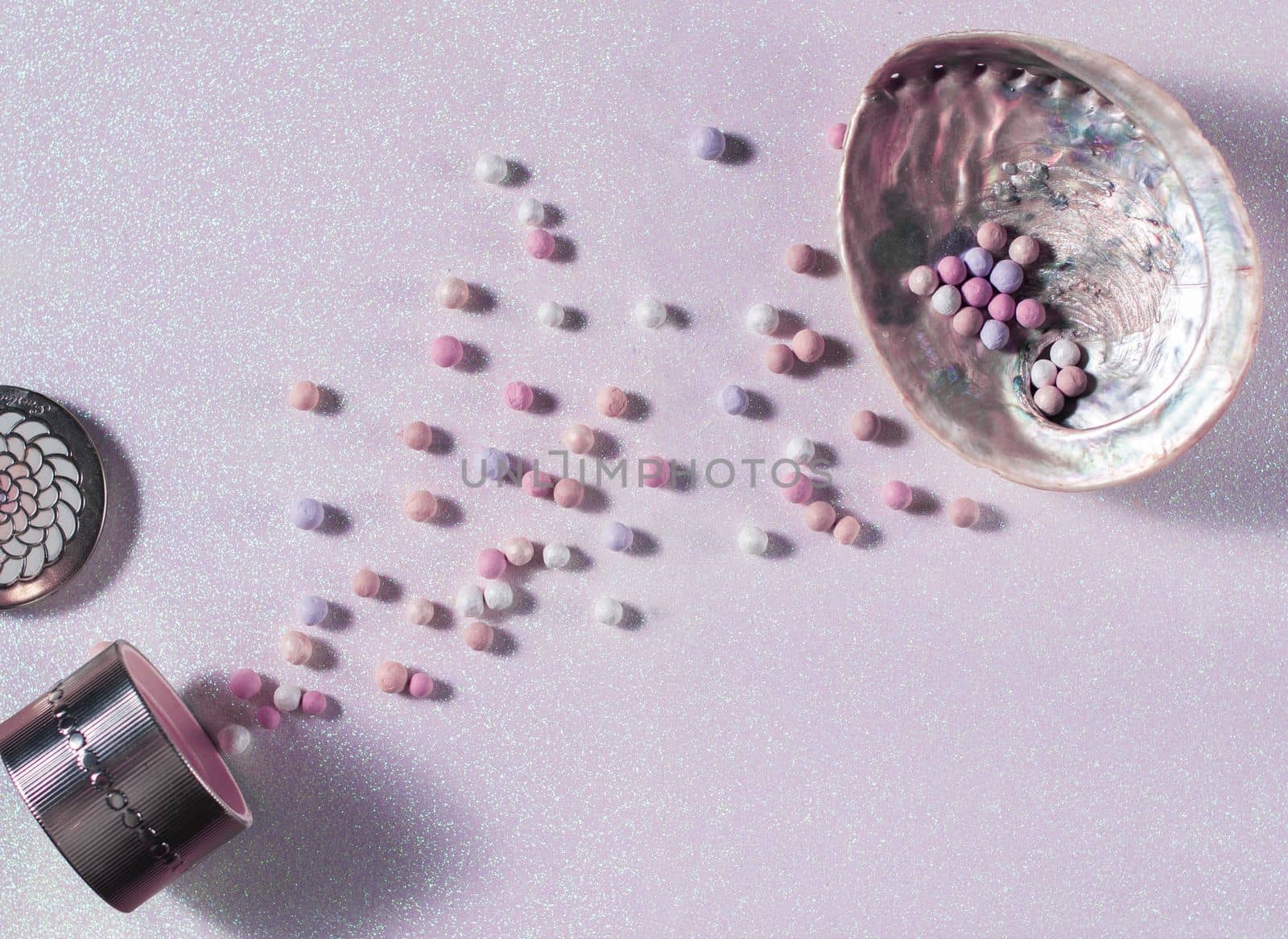 beautiful pearl balls of powder on a delicate pink surface and in a shell by KaterinaDalemans