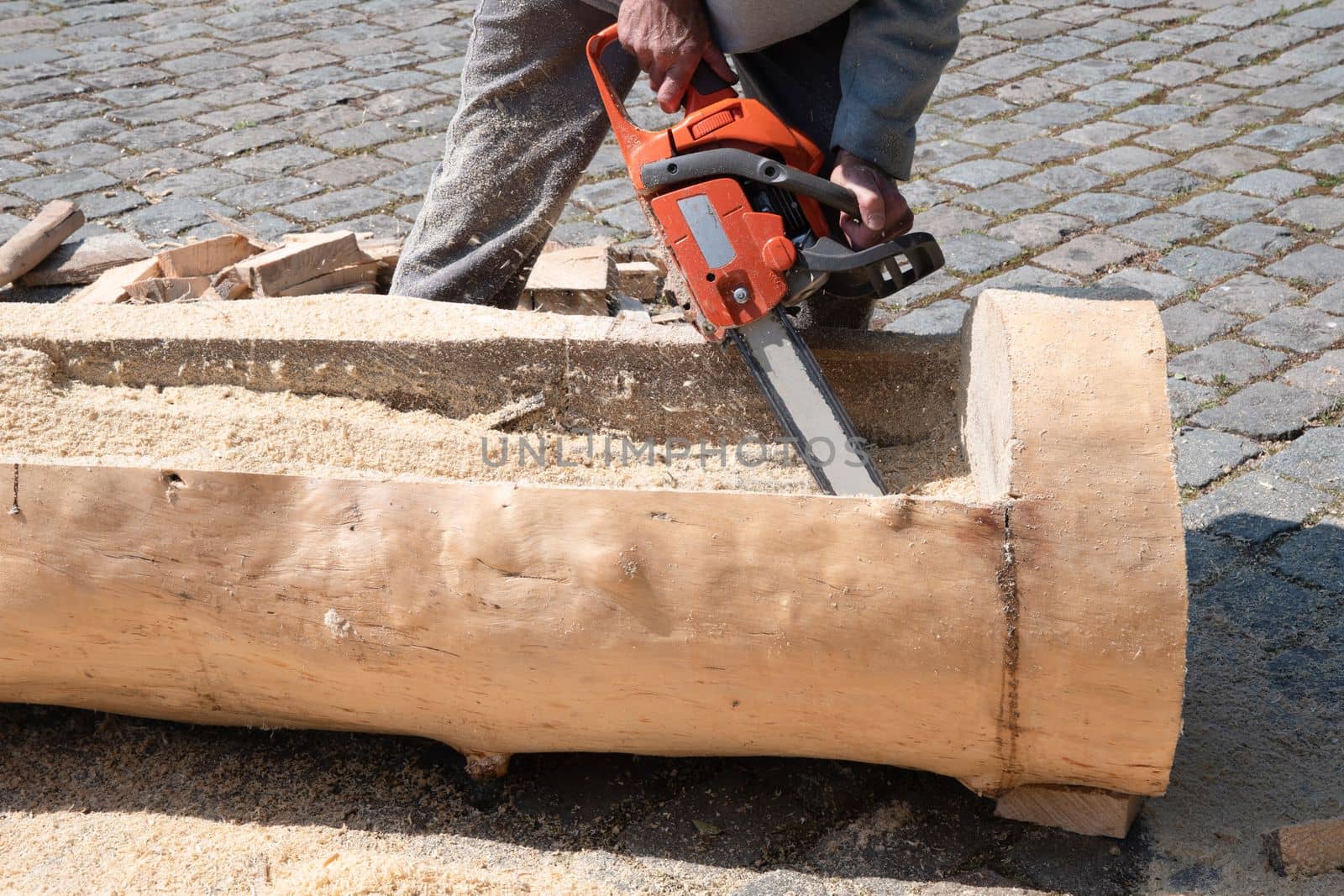 Chainsaw. Close-up of woodcutter sawing chain saw in motion, sawdust fly to sides. Concept is to bring down trees. High quality photo