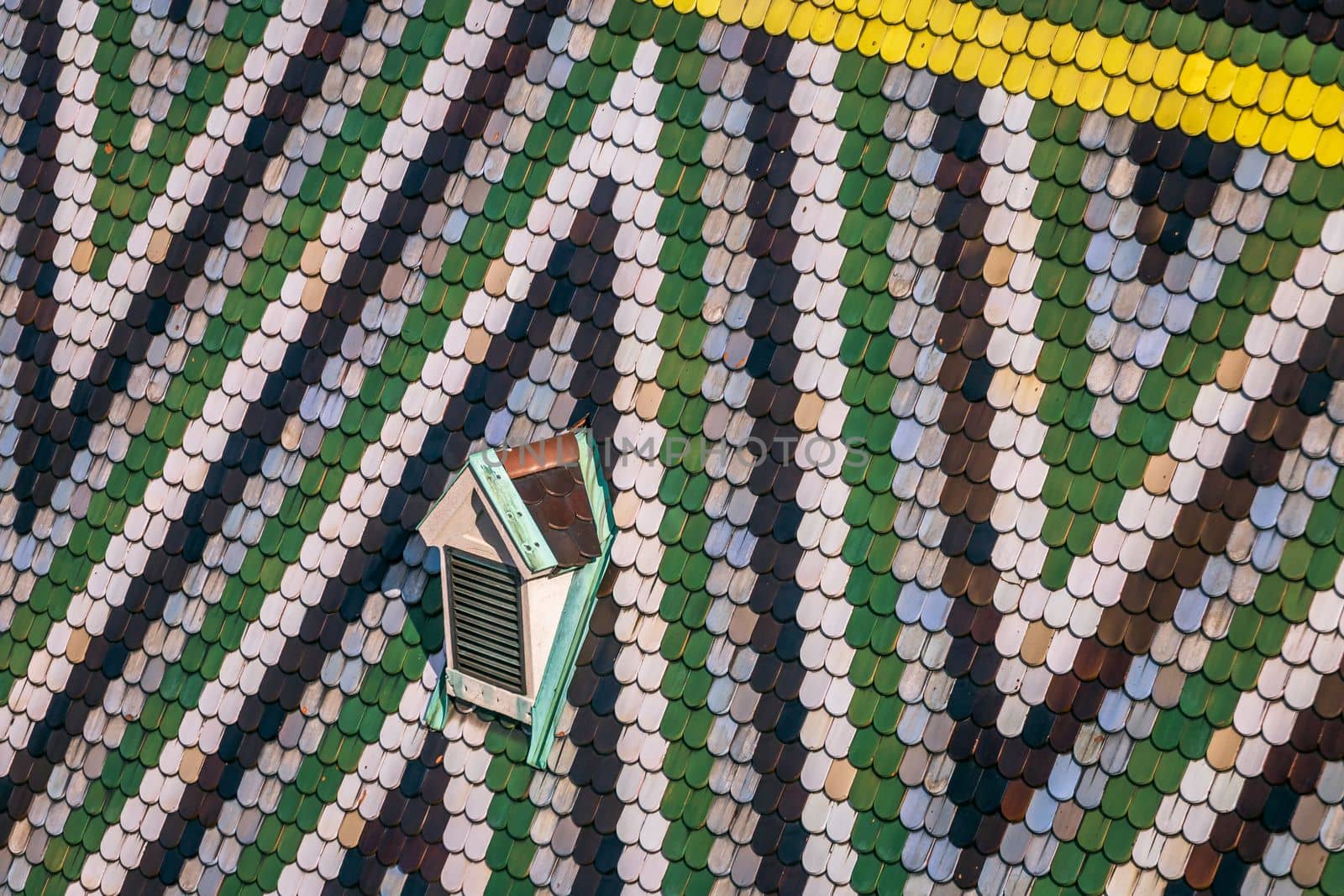 Abstract roof pattern with lonely window of St Stephen's Cathedral in Vienna by positivetravelart