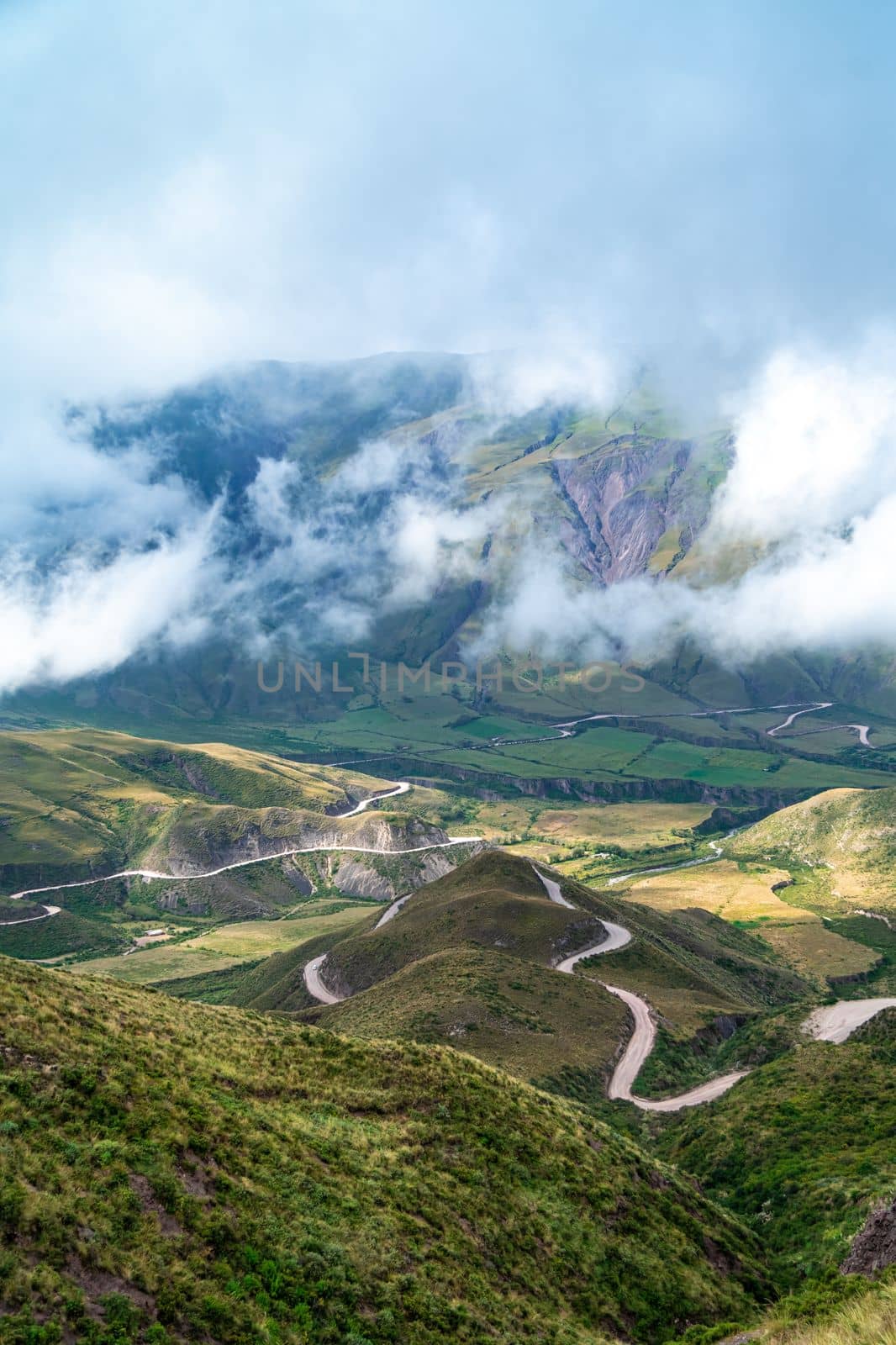 winding mountain roads in the Andes Mountains with a sky overcast with clouds.  by Edophoto