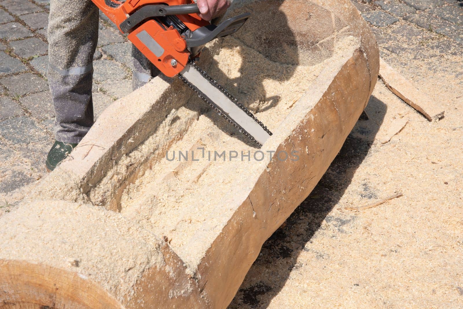 Chainsaw. Close-up of woodcutter sawing chain saw in motion, sawdust fly to sides. Concept is to bring down trees. High quality photo