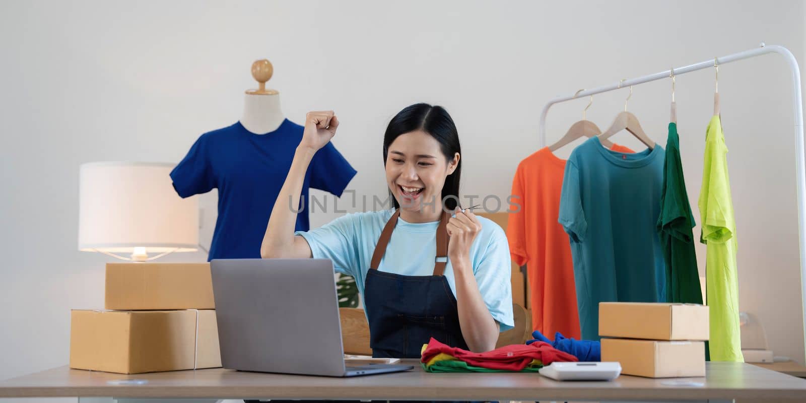 Young asian women happy after new order from customer. Surprise and shock face of asian woman success on making big sale of his online store. Online Selling.