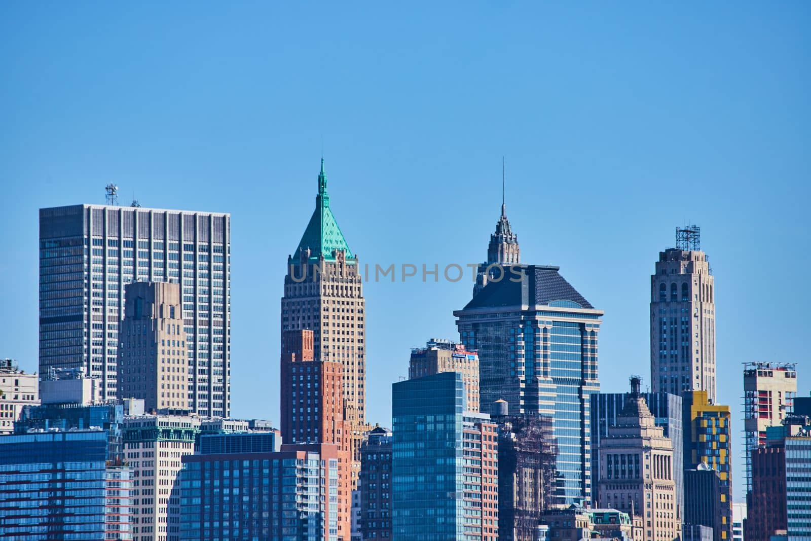 Image of New York City skyline detail of tops of skyscrapers with blue sky