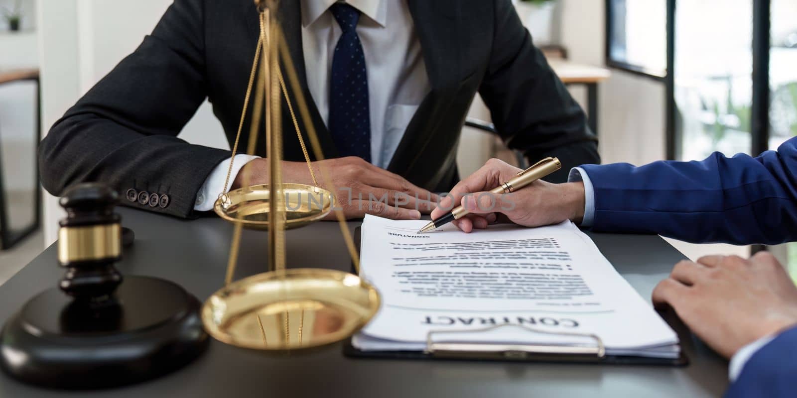 Business people and lawyers discussing contract papers with brass scale on wooden desk in office. Law, legal services, advice, Justice concept.
