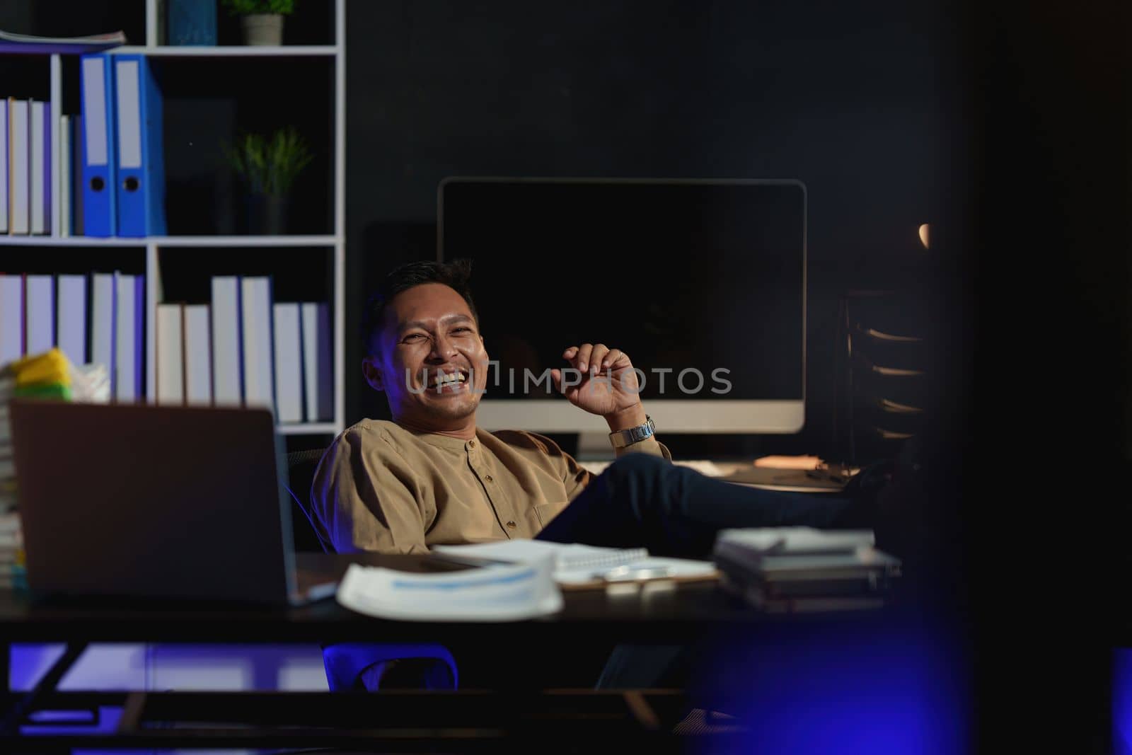Asian business man working over time at night. business account and finance concept.