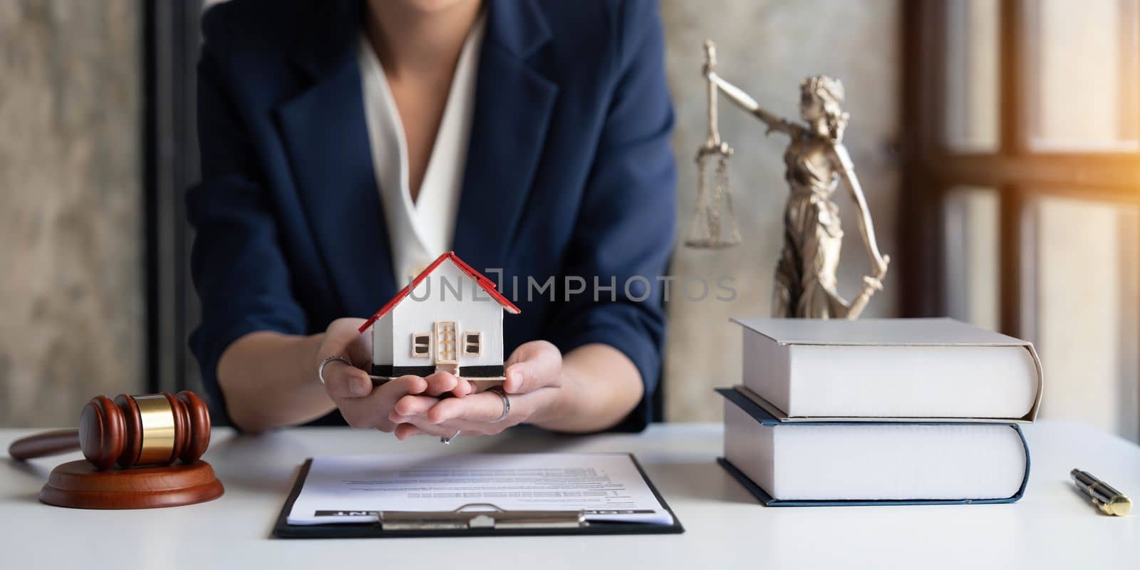 Real estate concept, businesswoman holding a house icon. House on Hand.Property insurance and security concept. Protecting gesture of female and symbol of house