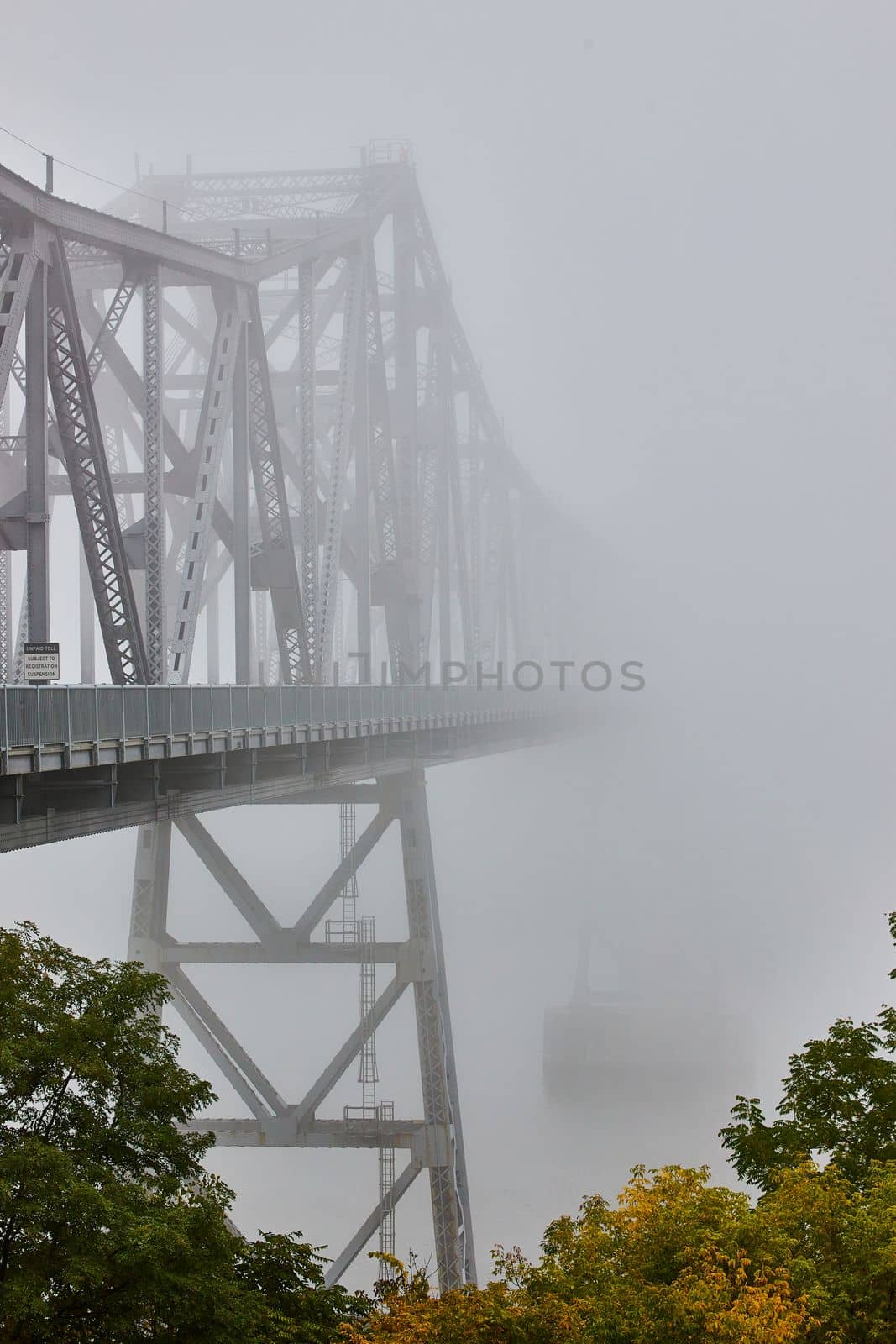 Image of View from outside of huge steel bridge fading away into nothing on extreme foggy weather morning