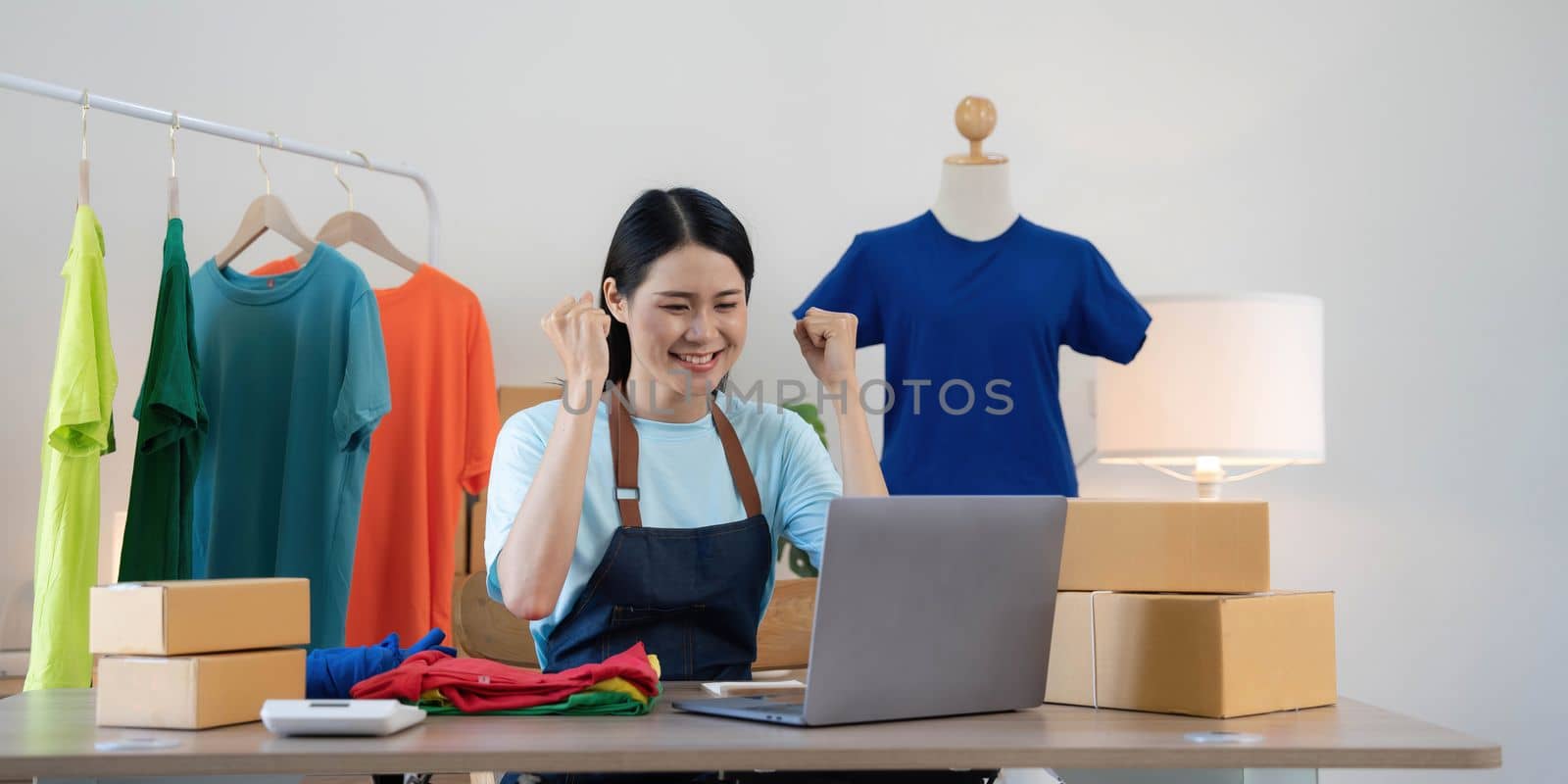 Young asian women happy after new order from customer. Surprise and shock face of asian woman success on making big sale of his online store. Online Selling.