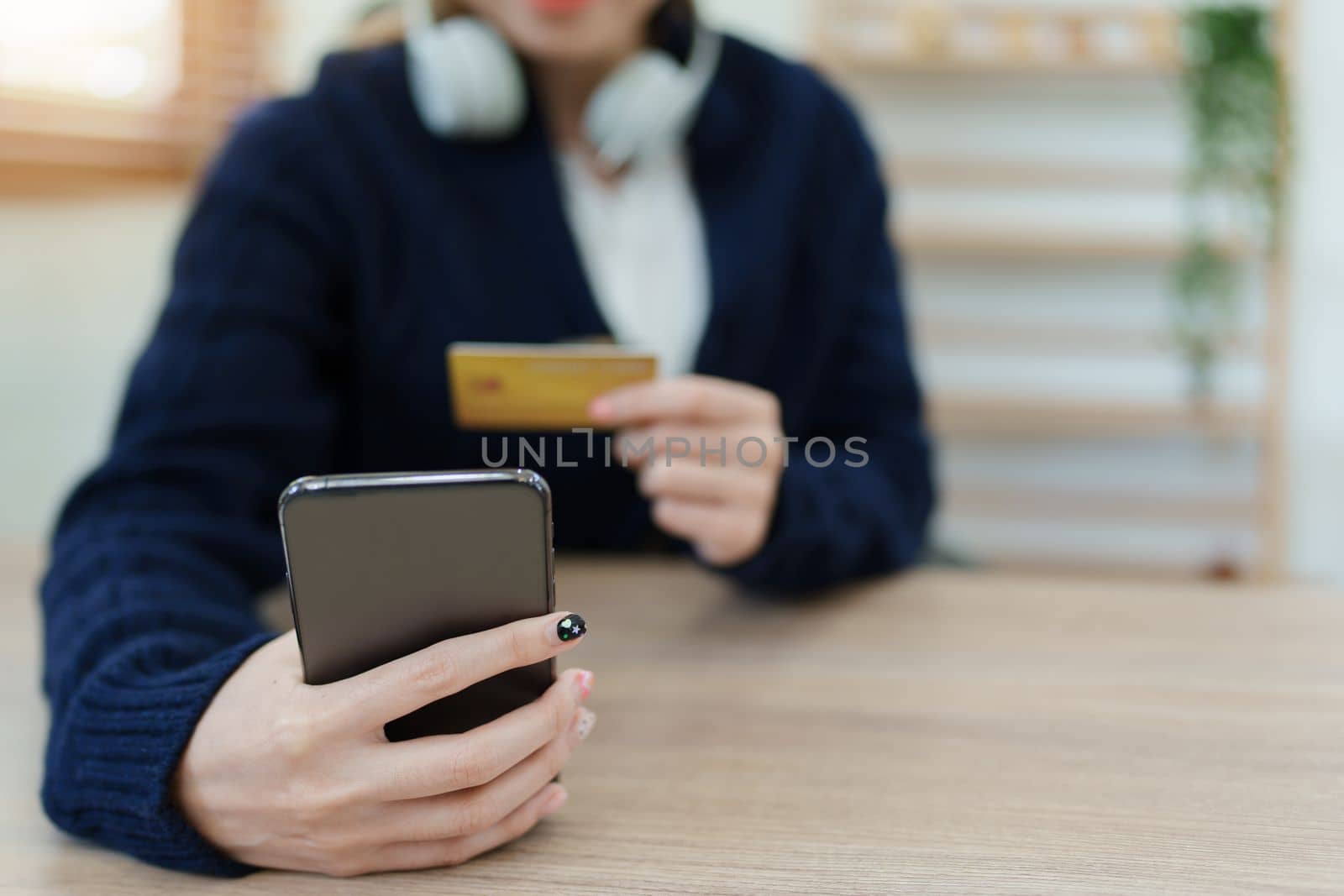 Online Shopping and Internet Payments, Asian man are using their credit card and mobile phone to shop online or conduct errands in the digital world. by Manastrong