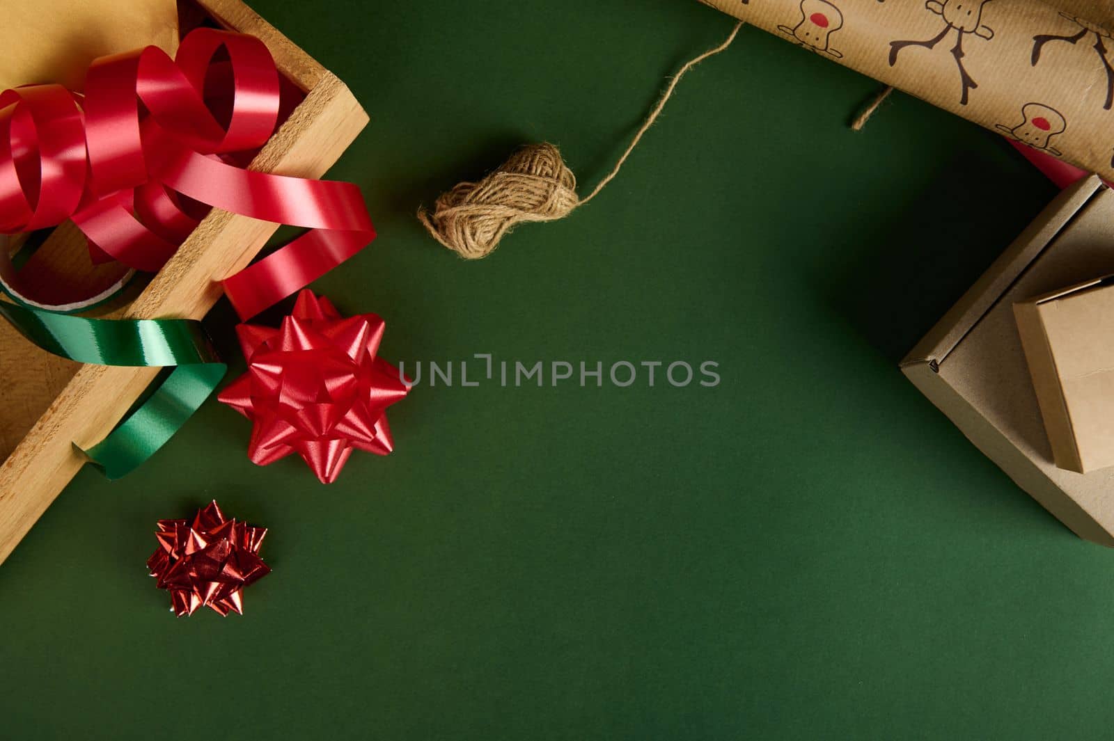 Christmas background with wrapping decorative materials for packing gifts for Xmas, New Year or any celebration event. Diy presents. Copy advertising space. Boxing day. Handwork art. Creativity