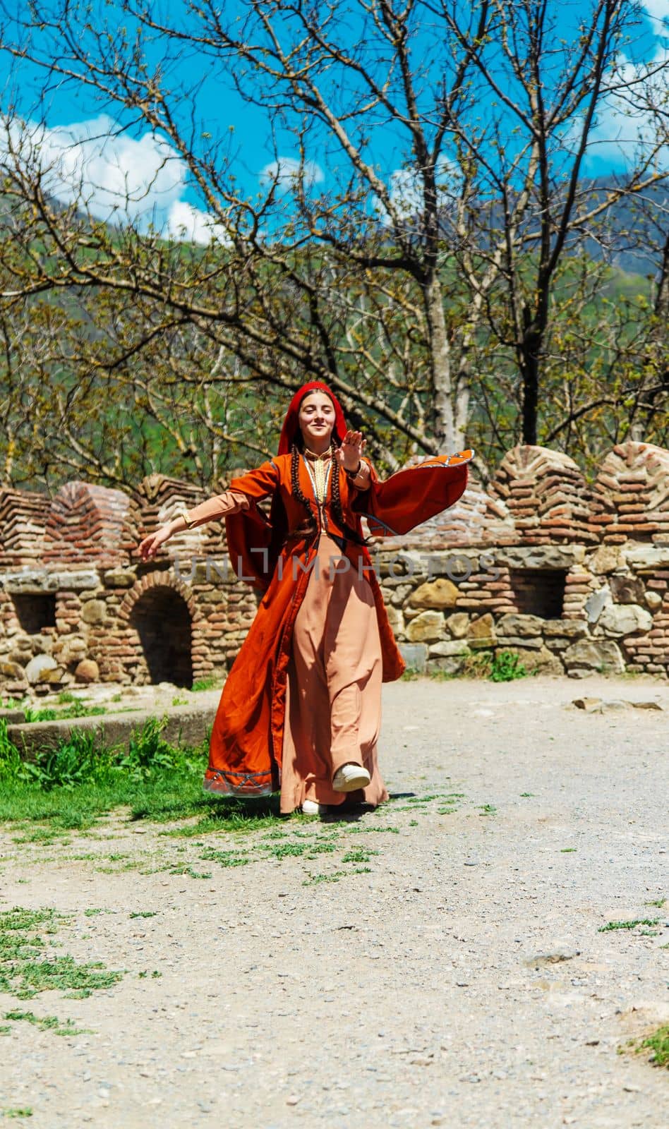Georgian girl in national costume dances Georgian national dances. selective focus. by mila1784