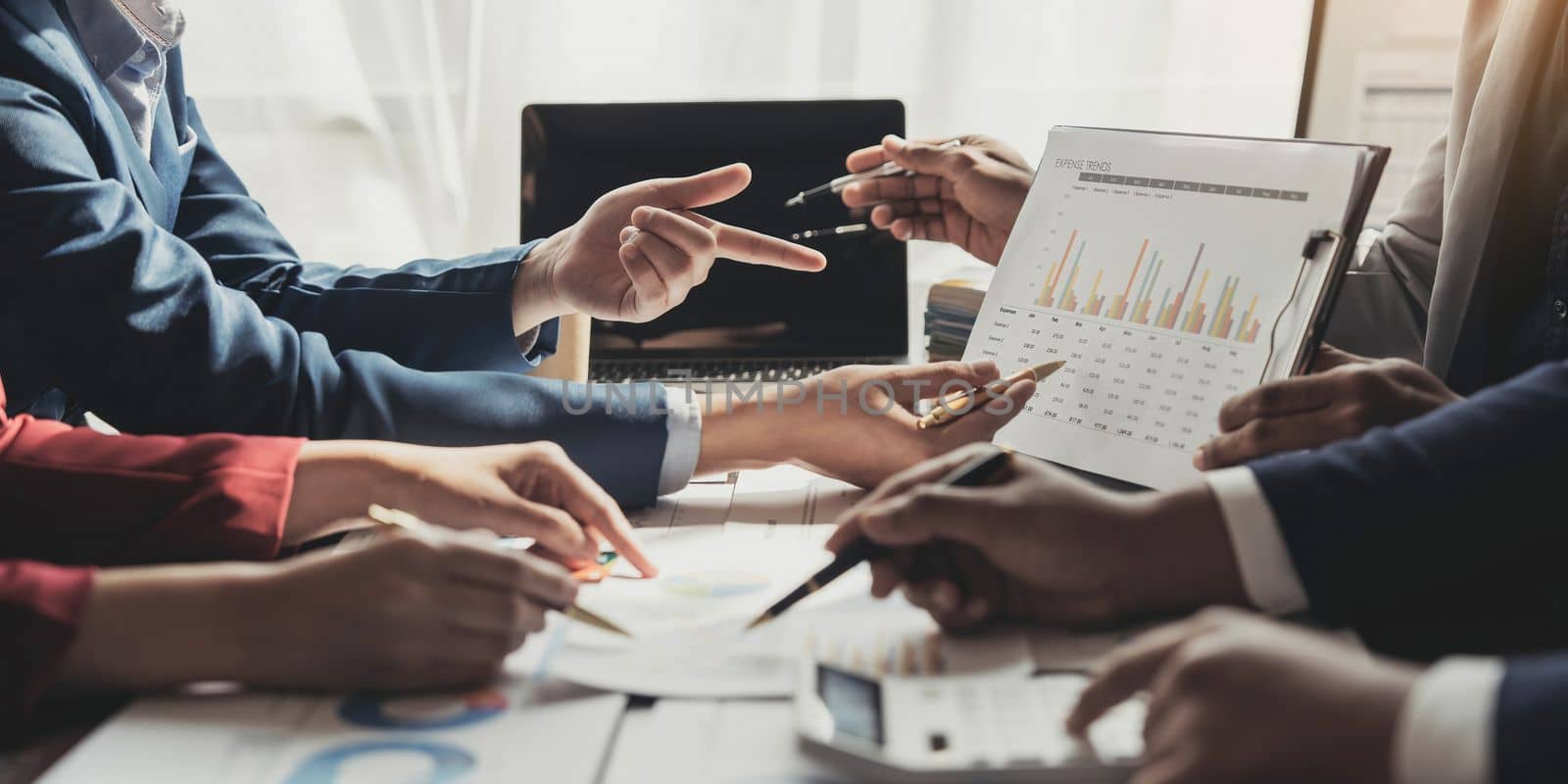 Business People Meeting using laptop computer,calculator,notebook,stock market chart paper for analysis Plans to improve quality next month. Conference Discussion Corporate Concept