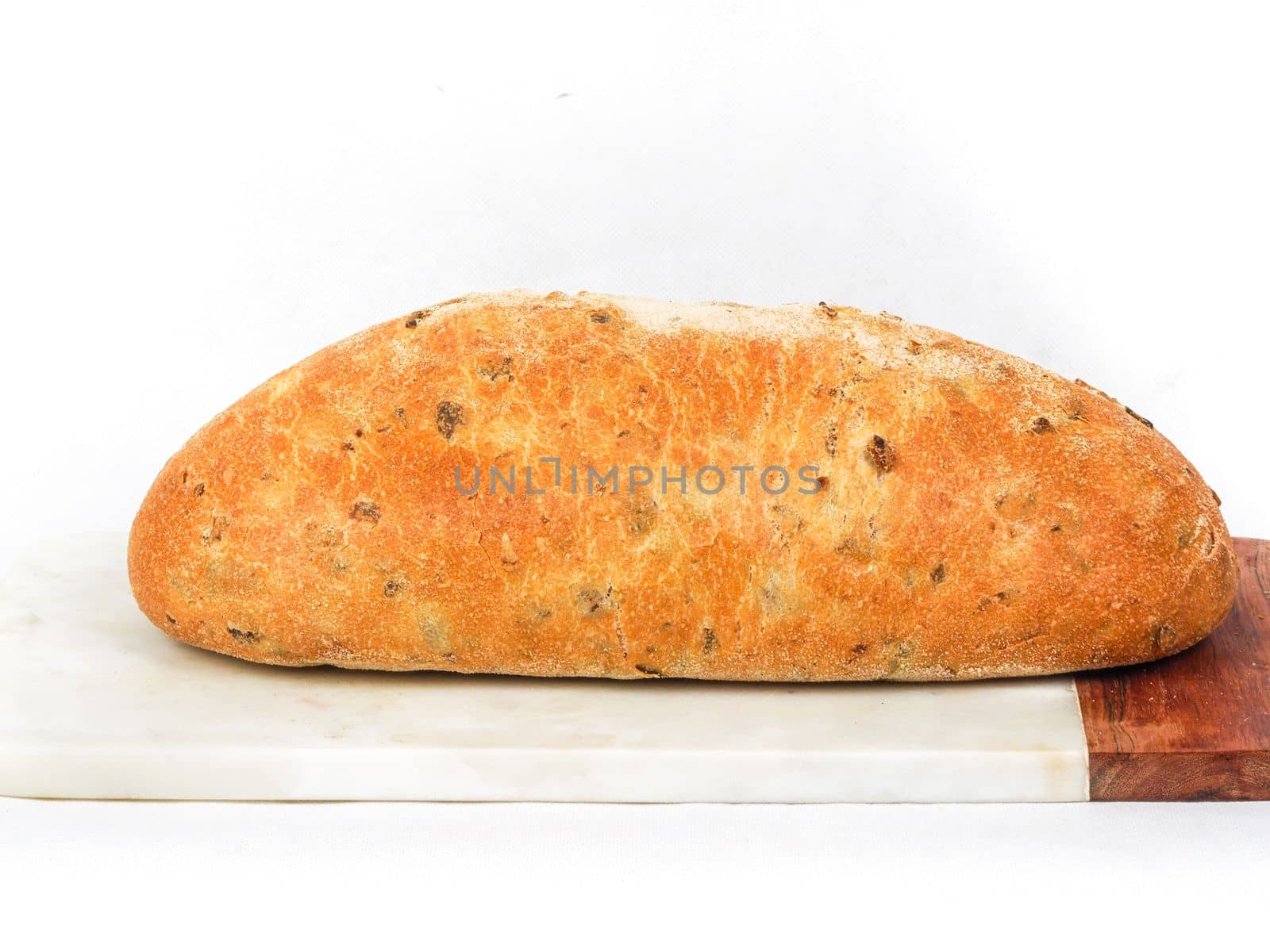 Olive loaf, olive bread, a bread laced with whole olives on white background