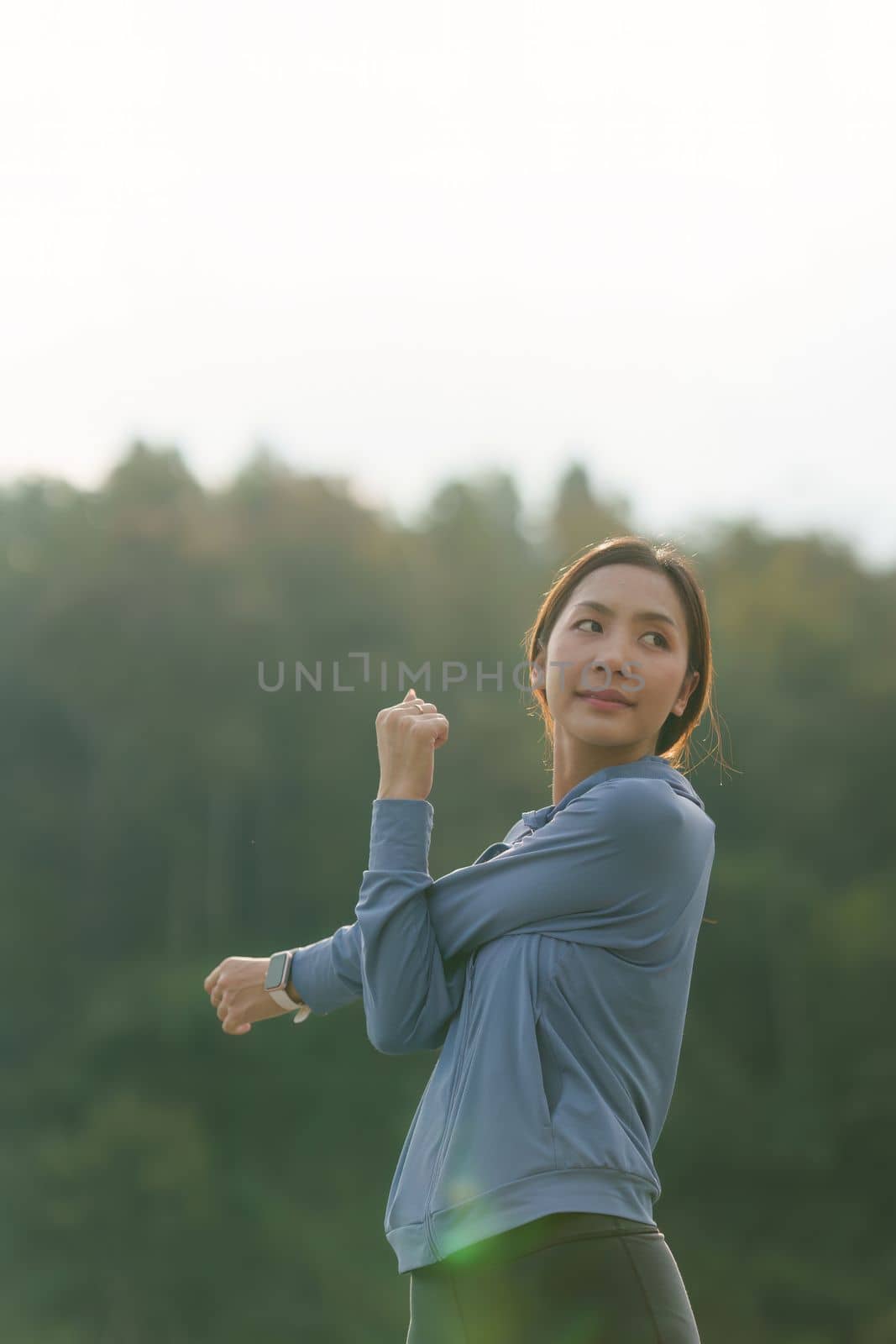 Healthy Asian woman is jogging outdoor. Fitness girl running. Female exercising at outdoor park.