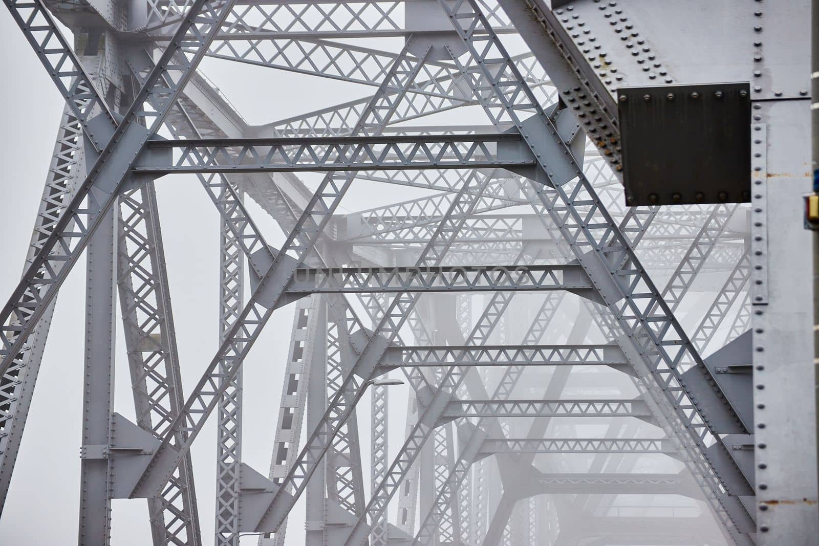 Inner top of old steel bridge fading in foggy morning by njproductions