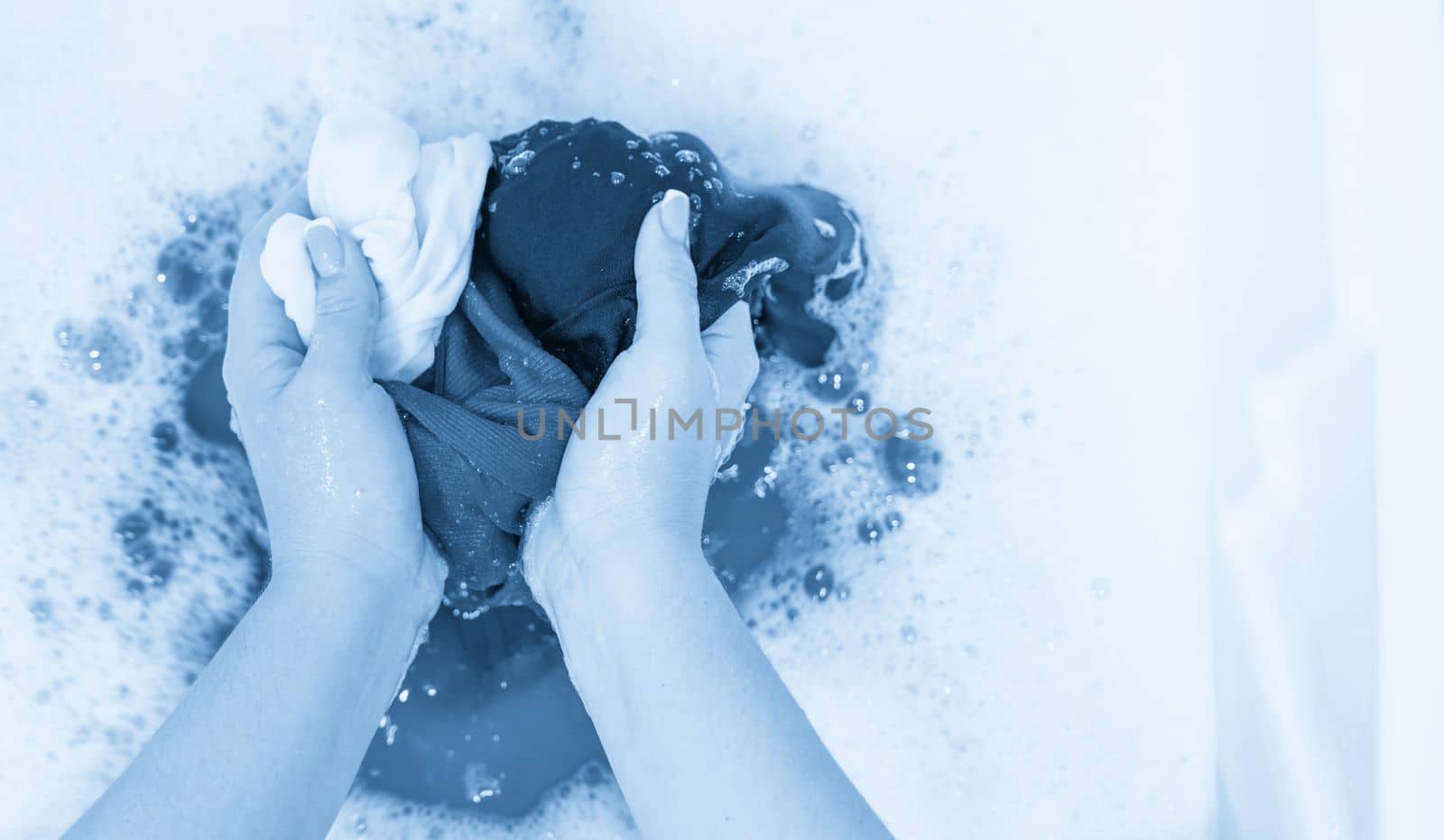 Handwashing in white sink with foam with copy space by Mariakray