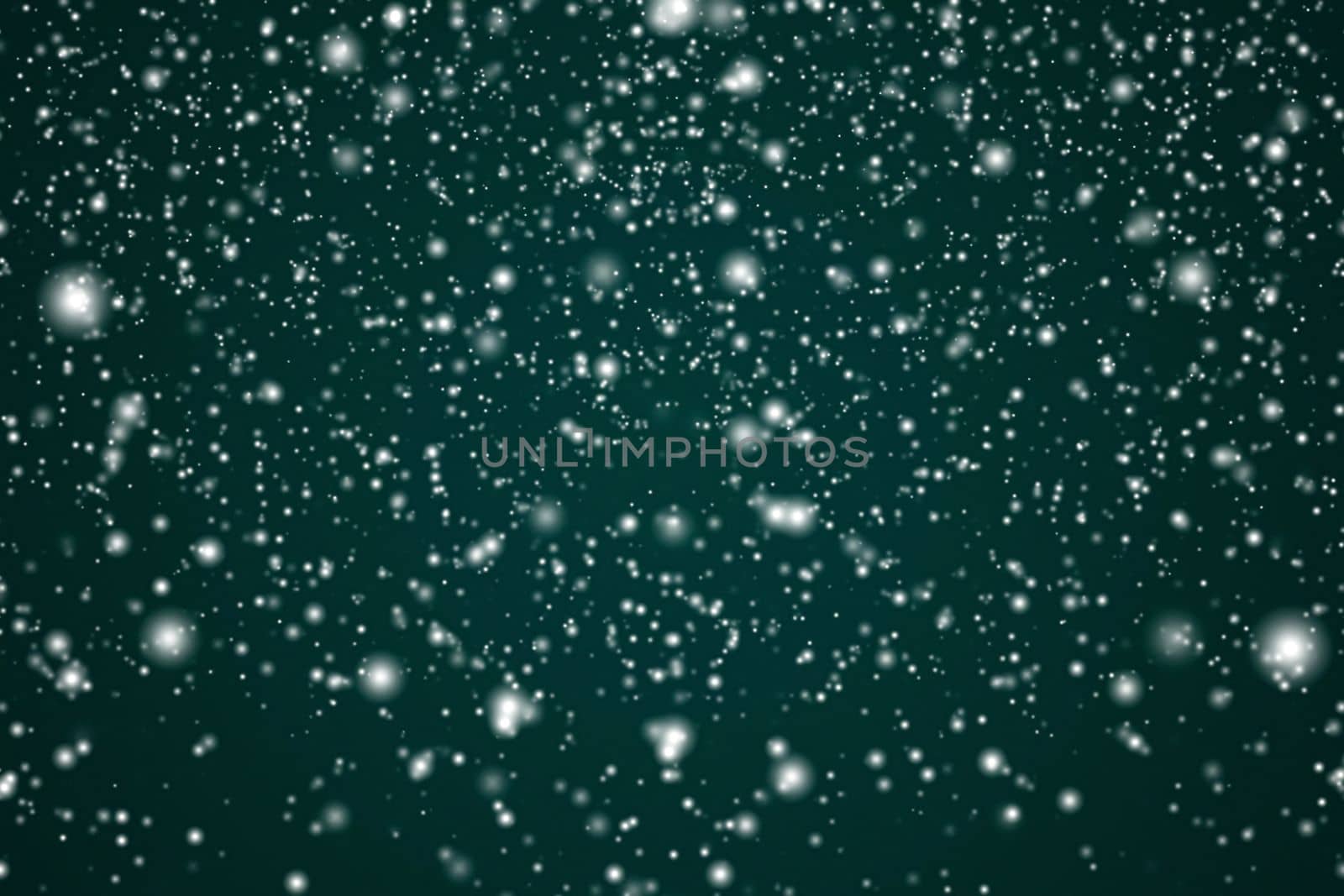 Winter holidays and wintertime background, white snow falling on festive green backdrop, snowflakes bokeh and snowfall particles as abstract snowing scene for Christmas and snowy holiday design. High quality 4k footage