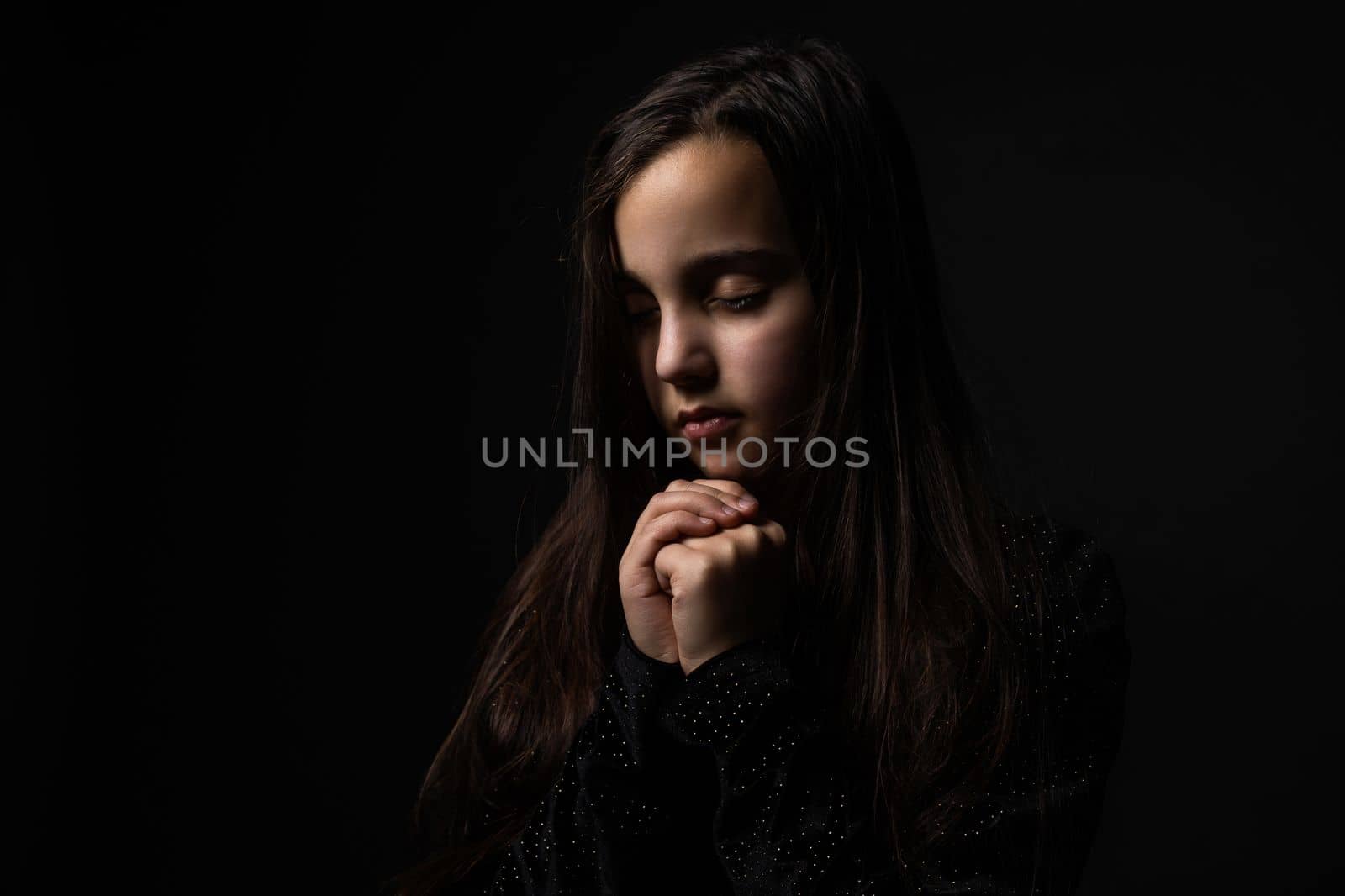 Portrait of a beautiful little baby girl praying. Facial expression. Kid and emotions. Faith and the Bible concept by Andelov13