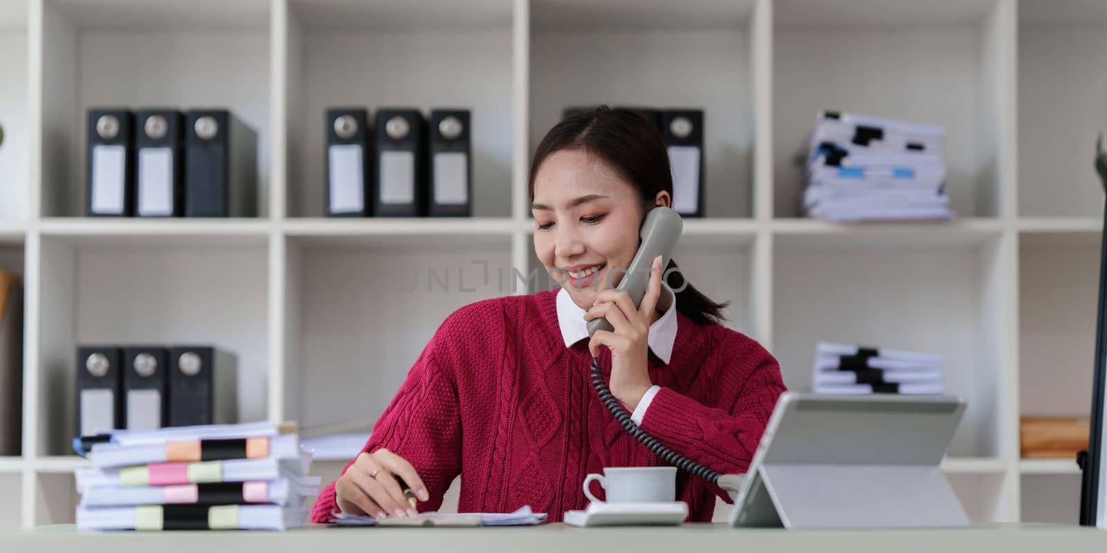 Pleasant positive business woman using digital tablet at home office by itchaznong